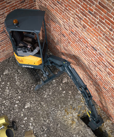 HX17A Z Hyundai Compact Excavator Digging against wall