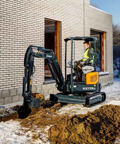 HX17A Z compacte graafmachine graaft een sleuf op een bouwplaats