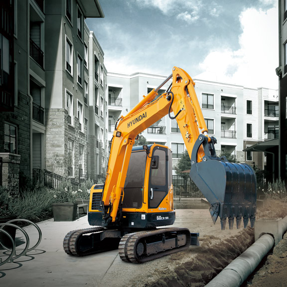 R60CR-9A compact excavator operating in an urban environment