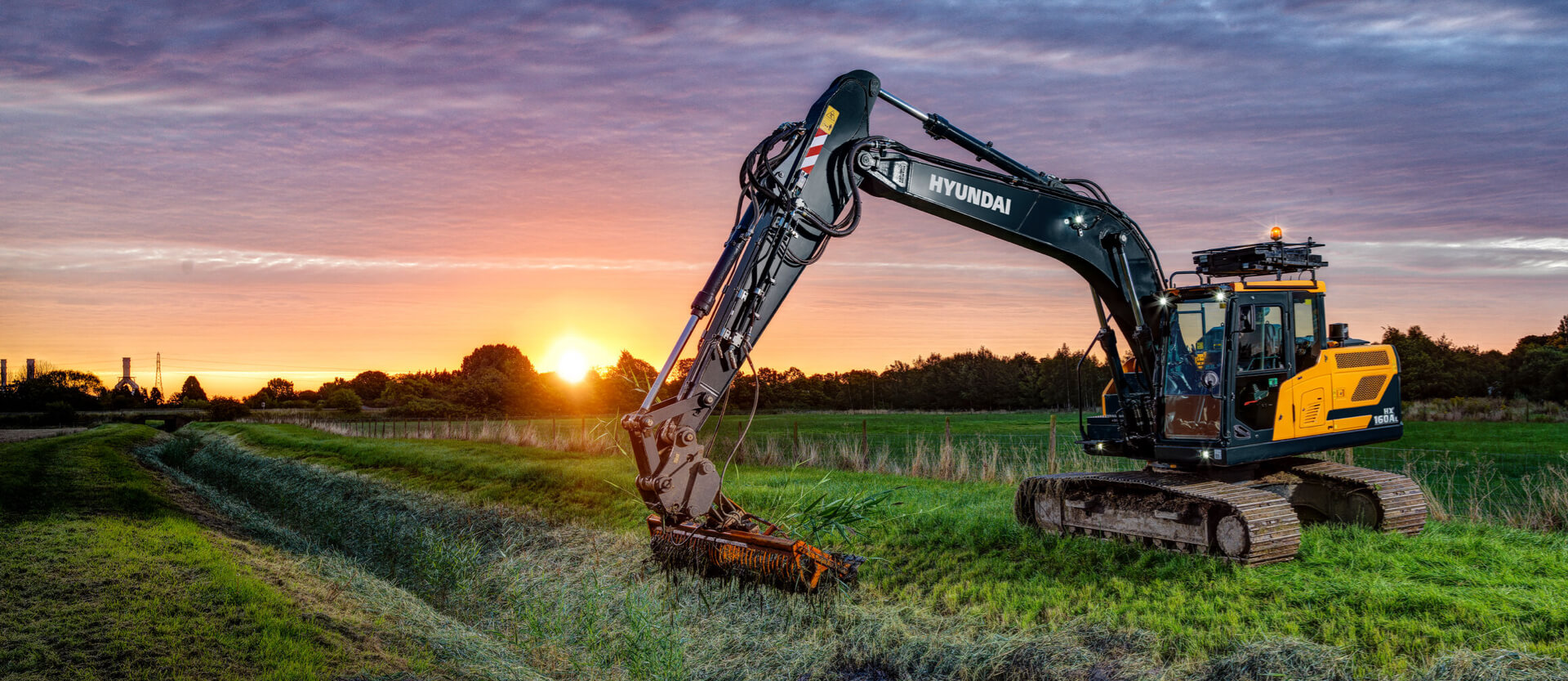 HD Hyundai HX160A L crawler excavator using the dredging bucket attachment