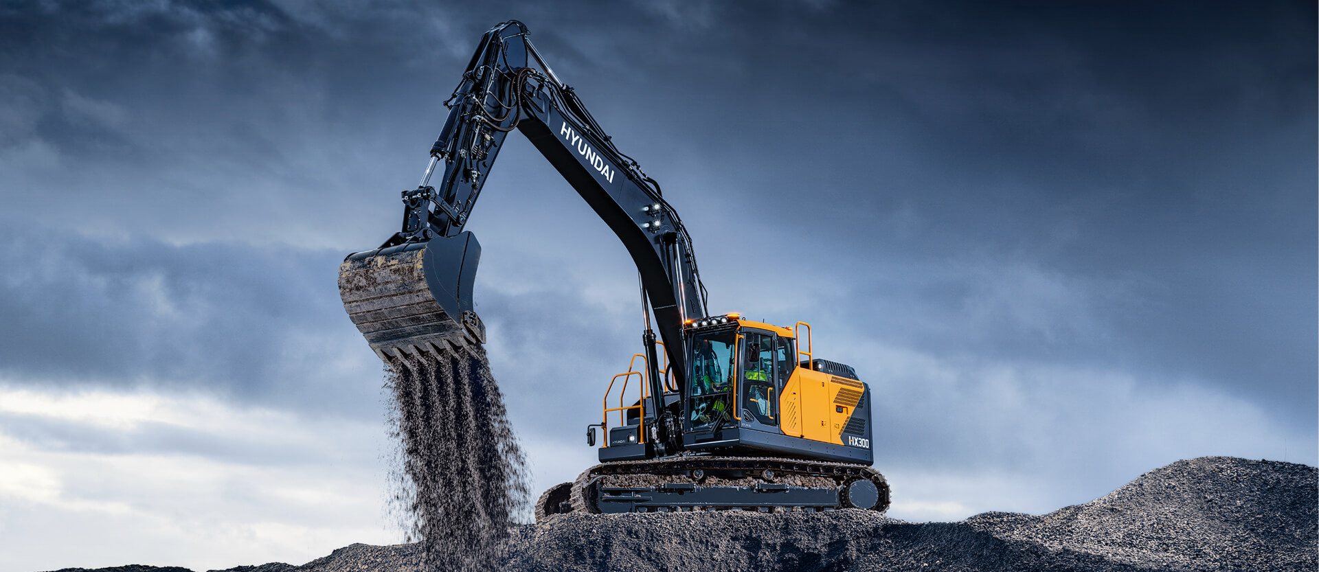 Hyundai HX300 Excavator dumping dirt in a quarry application