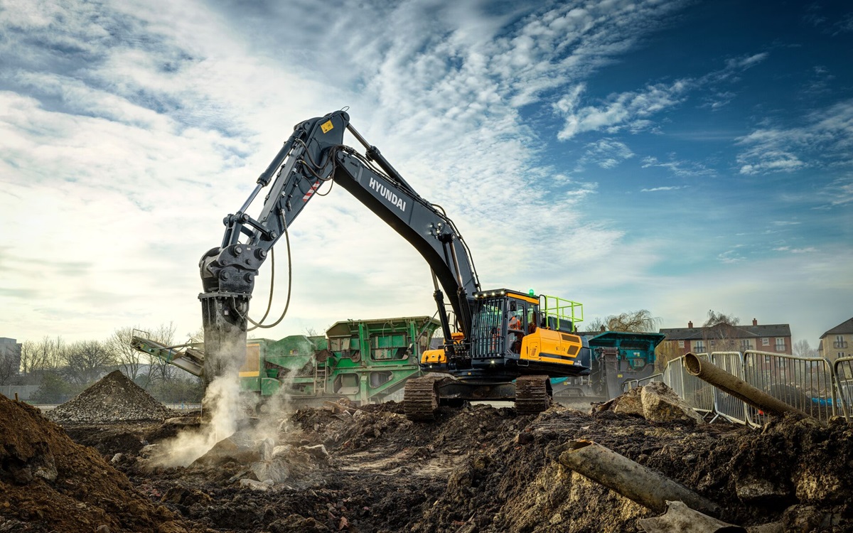 HD Hyundai HX480AL breaking with the hammer attachment on a construction site