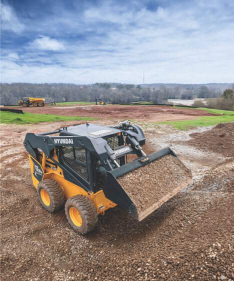 Hyundai HS120V Skid Steer Loader working on construction site