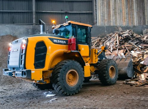 The HD Hyundai HL940A wheel loader moving material at a recycling centre